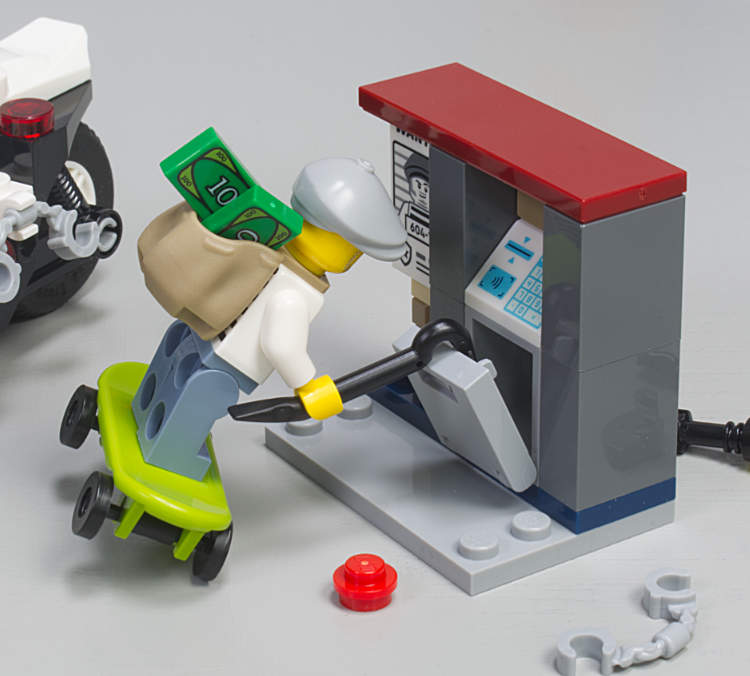 crook breaking into ATM